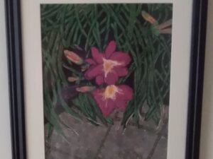 A framed Painting #21 of pink flowers on a wall.