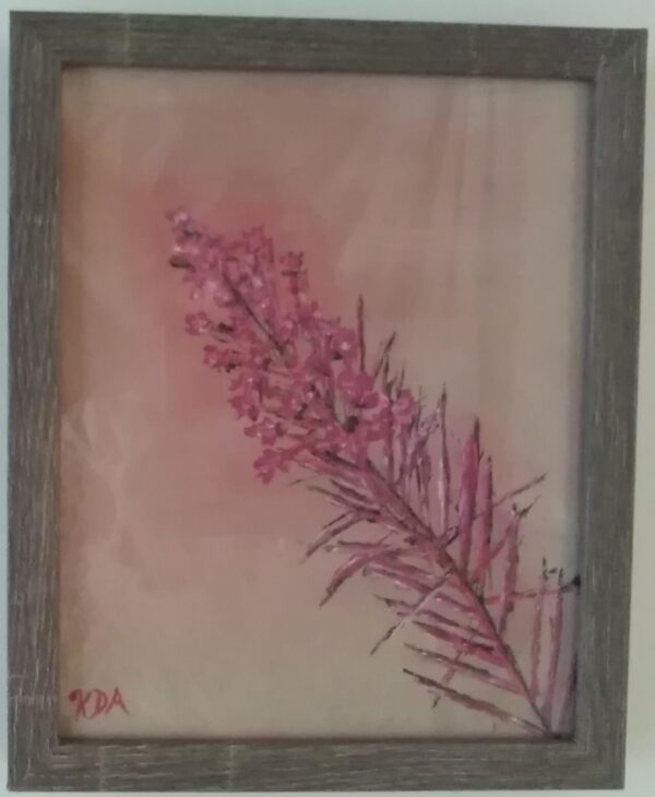 A pink flower is framed in a wooden frame.