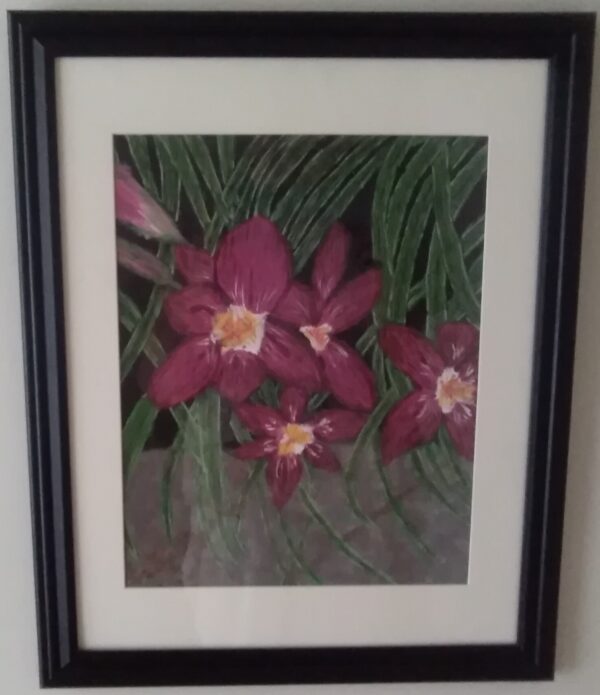 A framed painting of orchids in a black frame.