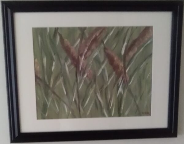 A painting of reeds in a black frame.