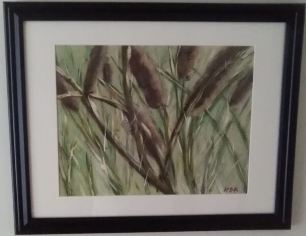 A painting of cattails in a black frame.