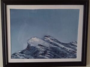 A framed painting of a mountain with snow on it.