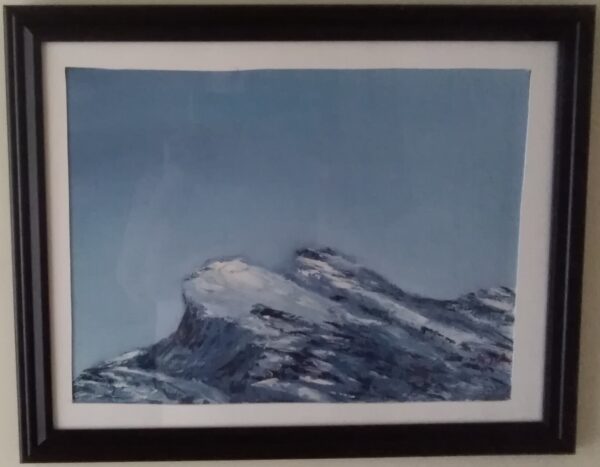 A framed painting of a mountain with snow on it.