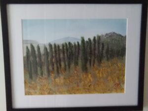 A painting of cypress trees on a wall.