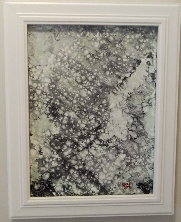 Black, green and white cell art painting in a frame