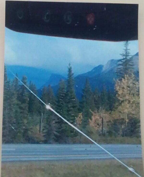 A picture of a road with mountains in the background.