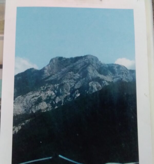 A photo of a mountain with mountains in the background.