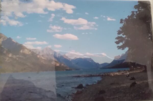 A photo of a lake with mountains in the background.