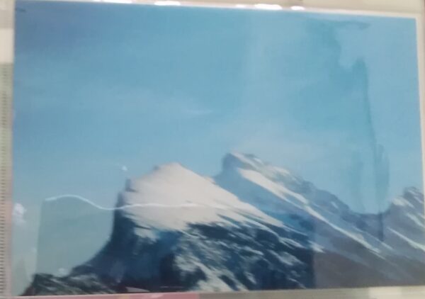 A picture of a mountain in a glass frame.